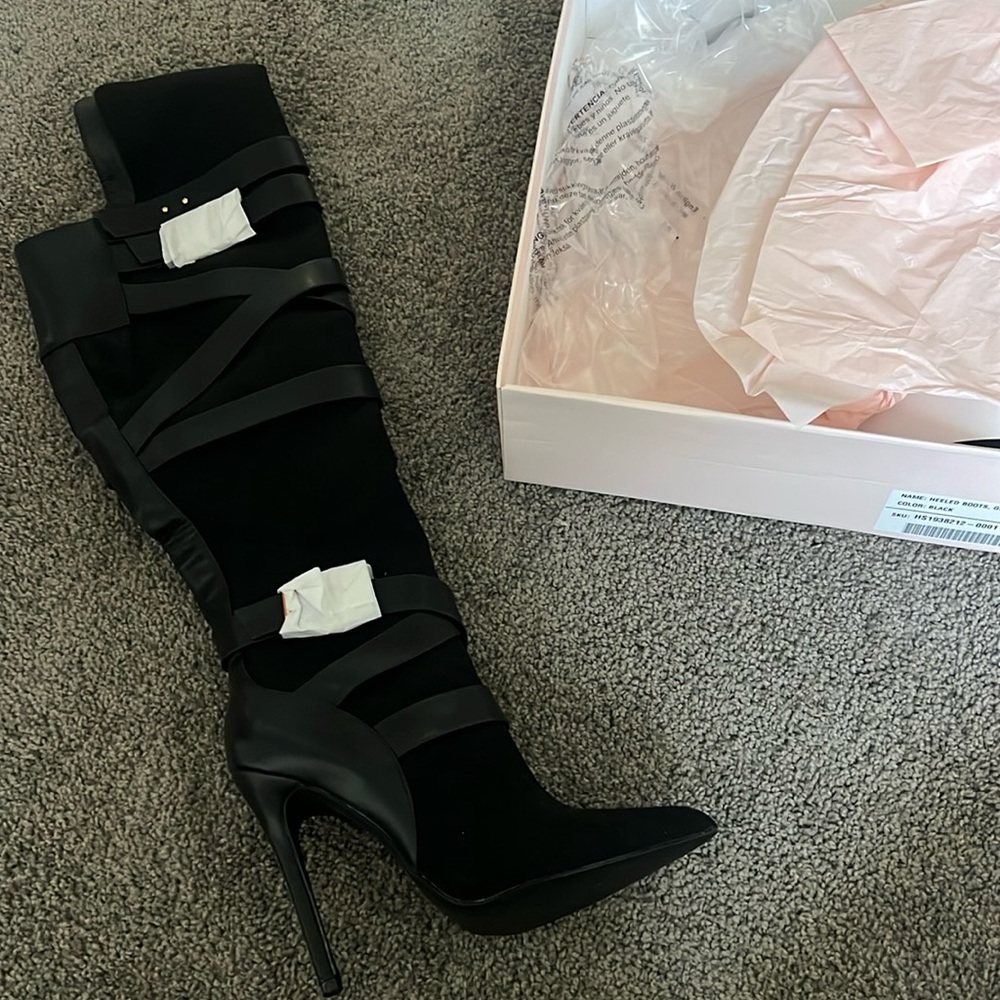 Black heeled knee high boots